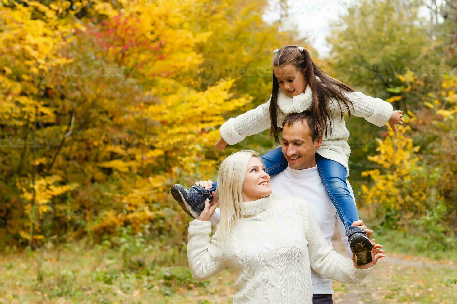 family, childhood, season and people concept - happy family in autumn park photo