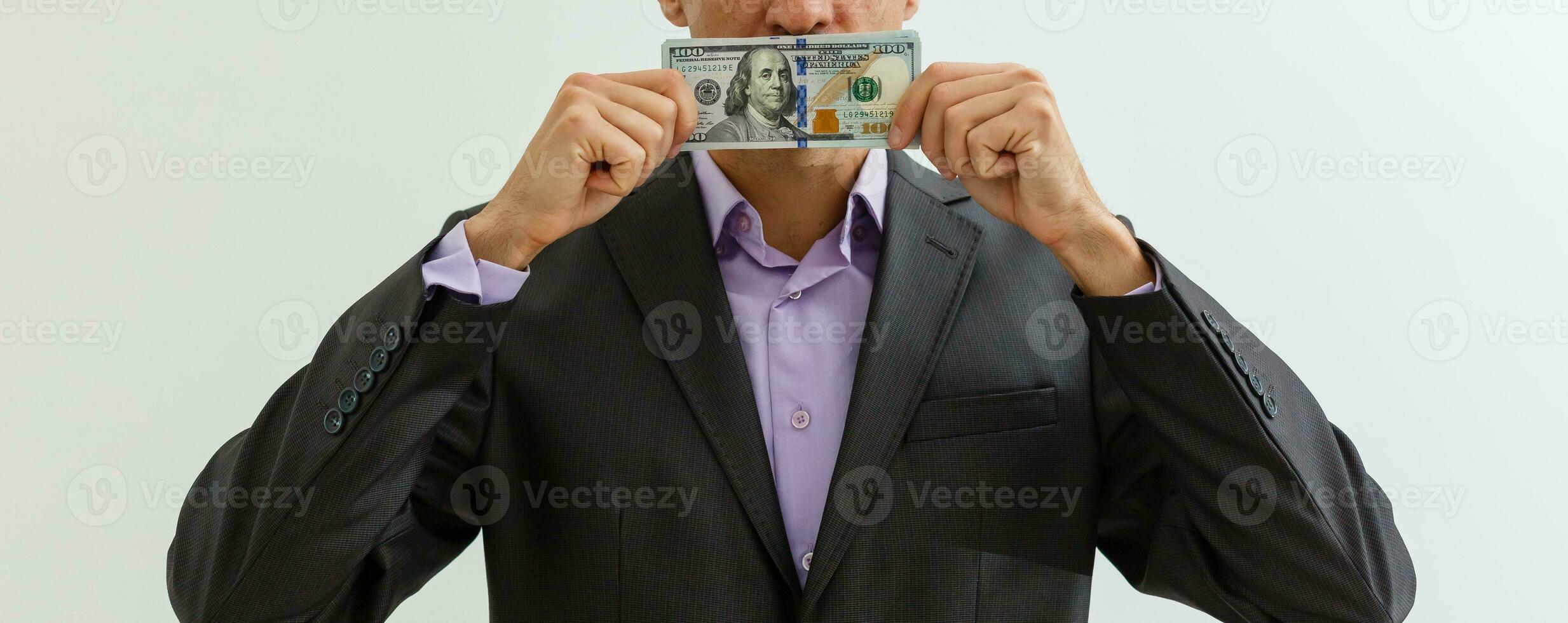 Panoramic shot of man covering face while smelling dollar banknotes photo