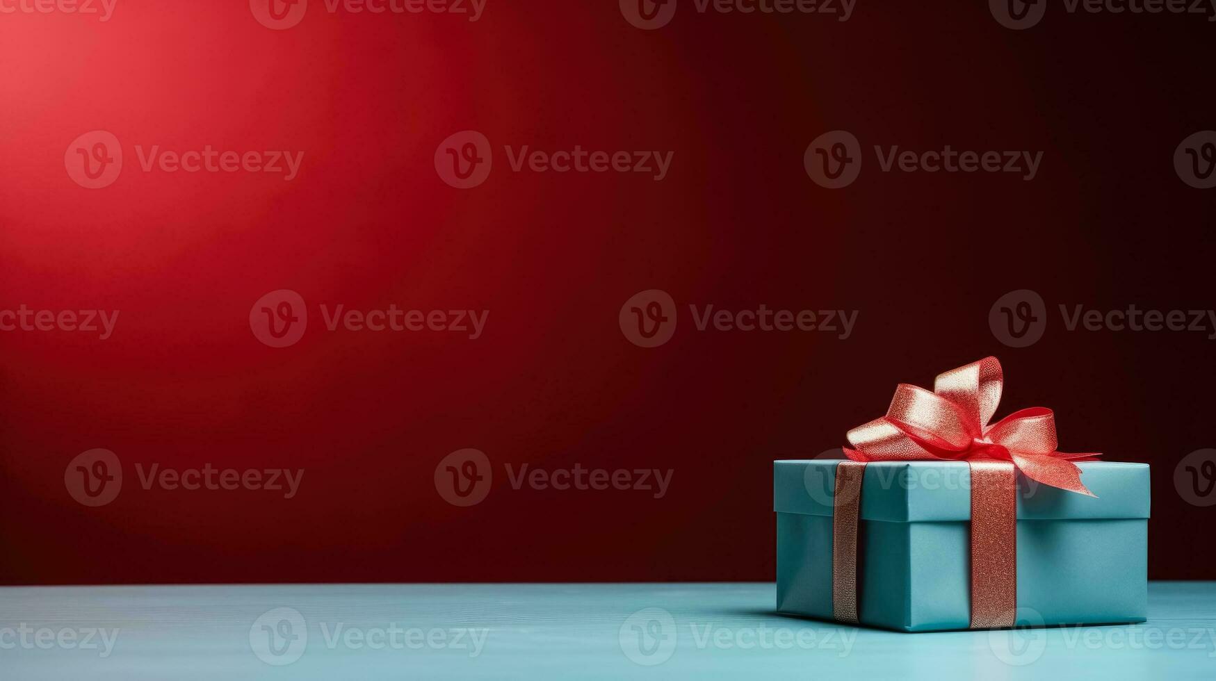 Gift box on a blue table on a vivid red background with empty space for text photo