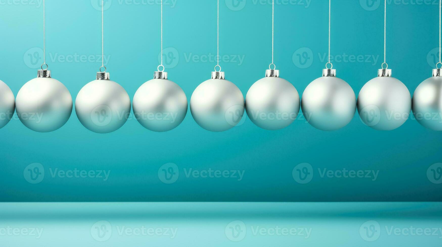 Silver christmas baubles isolated on a vibrant blue background photo