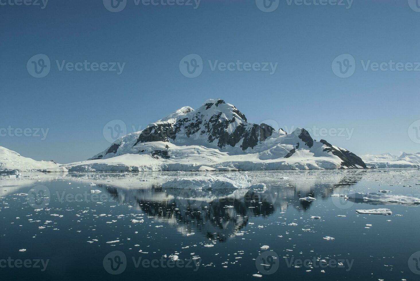 Lemaire strait coast, mountains and icebergs, Antartica photo