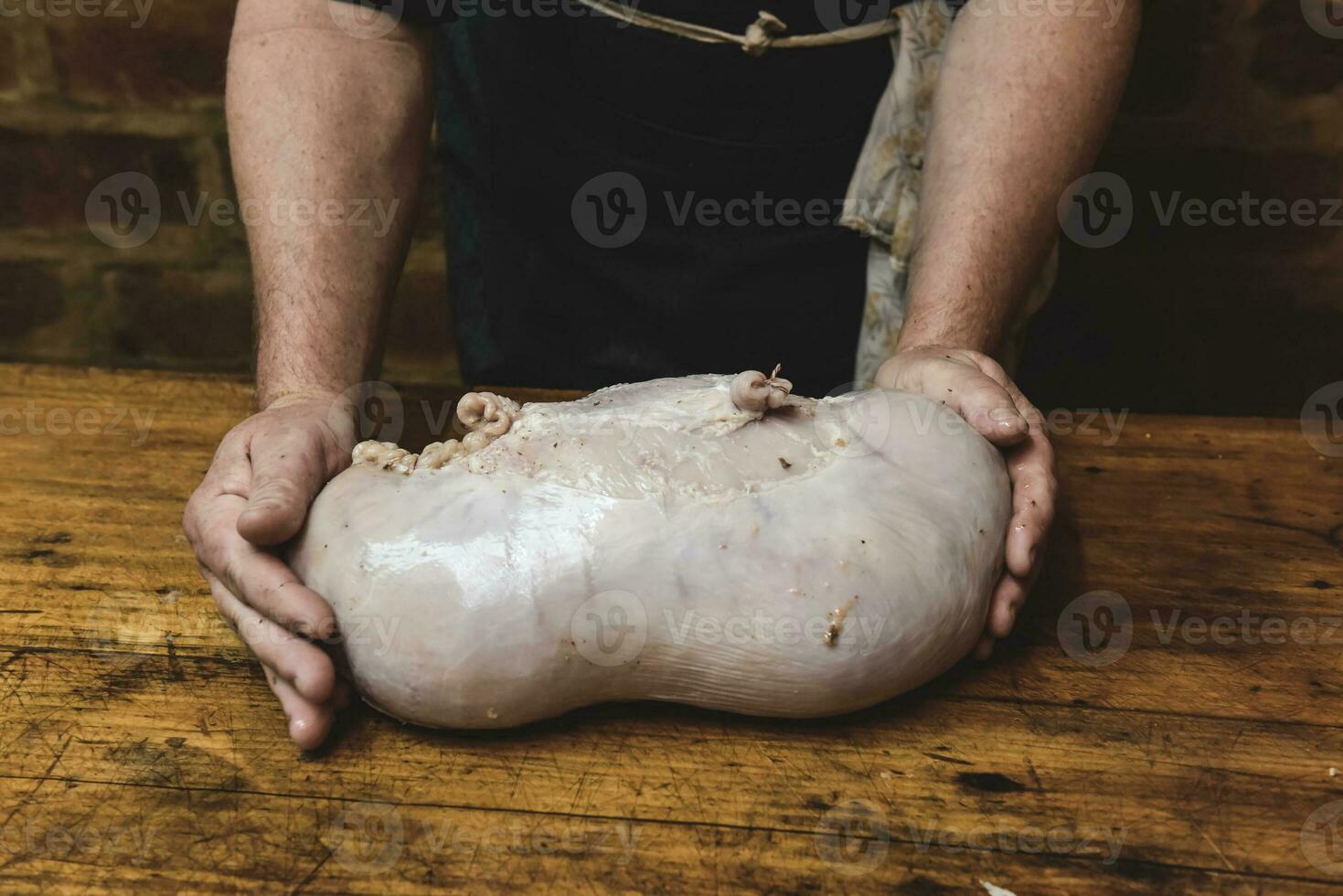Hands making homemade head cheese, Patagonia, Argentina photo