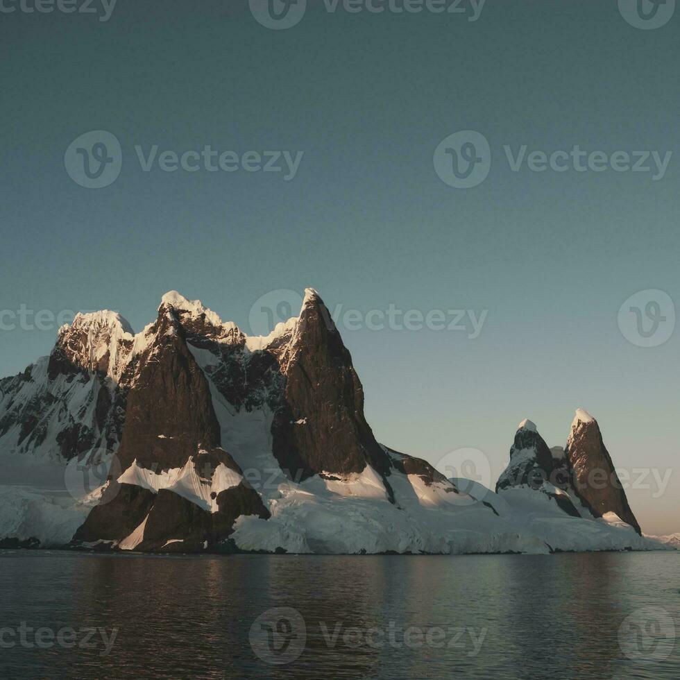 Lemaire strait coastal landscape, mountains and icebergs, Antarctic Peninsula, Antartica. photo