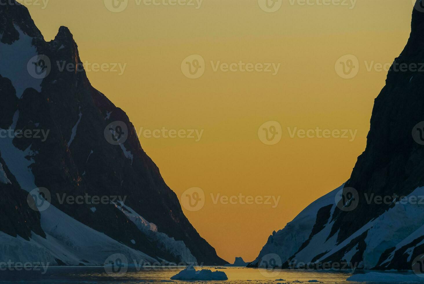 Lemaire strait coastal landscape, mountains and icebergs, Antarctic Peninsula, Antartica. photo