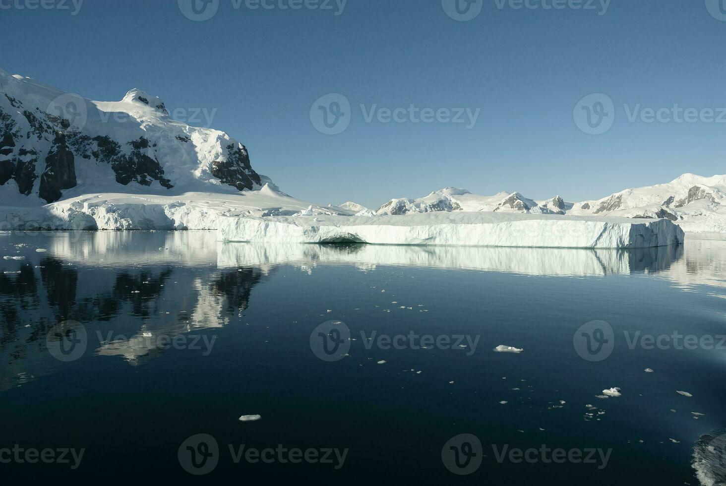 Lemaire strait coastal landscape, mountains and icebergs, Antarctic Peninsula, Antartica. photo