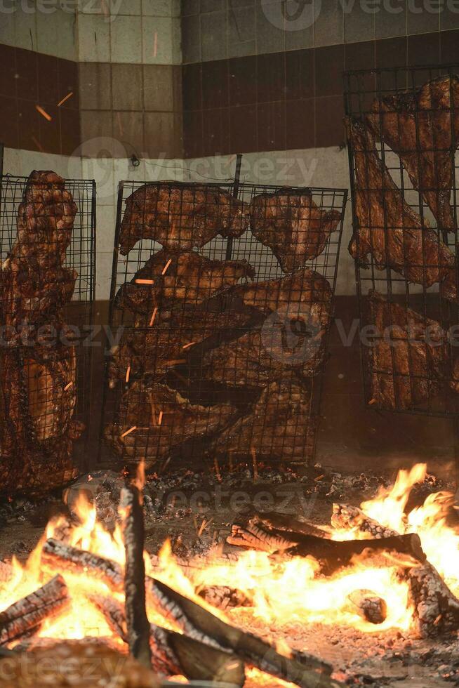 Barbecue, sausage and cow ribs, traditional argentine cuisine, Patagonia, Argentina. photo