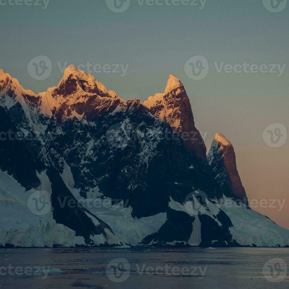 Lemaire strait coastal landscape, mountains and icebergs, Antarctic Peninsula, Antartica. photo