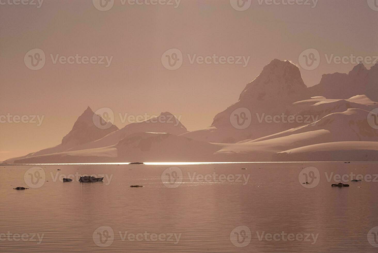 Lemaire strait coastal landscape, mountains and icebergs, Antarctic Peninsula, Antartica. photo
