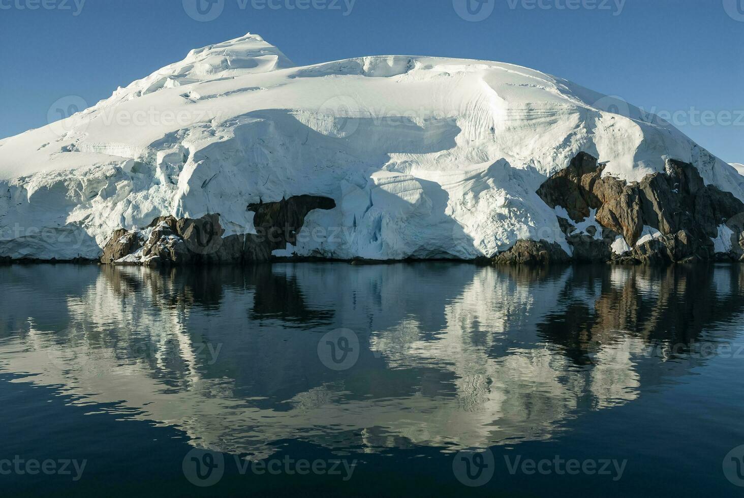 Lemaire strait coastal landscape, mountains and icebergs, Antarctic Peninsula, Antartica. photo