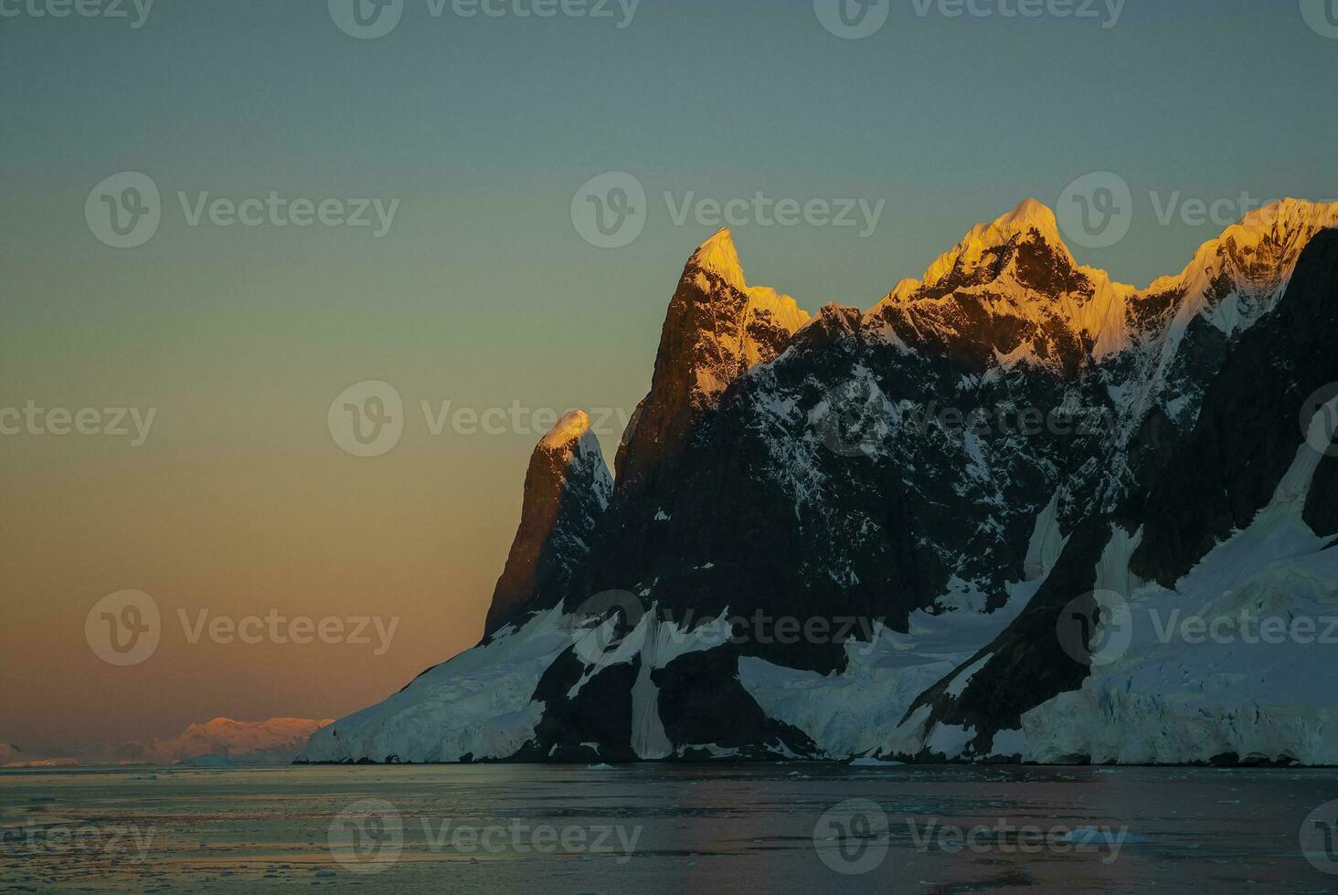 Lemaire strait coastal landscape, mountains and icebergs, Antarctic Peninsula, Antartica. photo