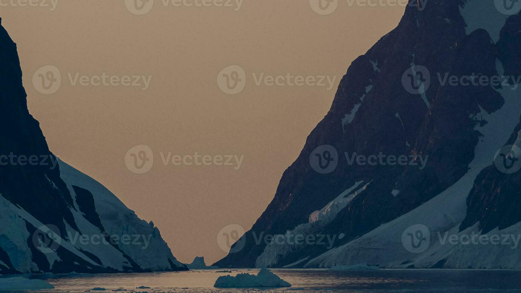Lemaire strait coastal landscape, mountains and icebergs, Antarctic Peninsula, Antartica. photo