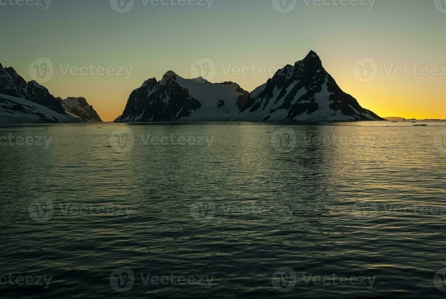 Lemaire strait coast, mountains and icebergs, Antartica photo