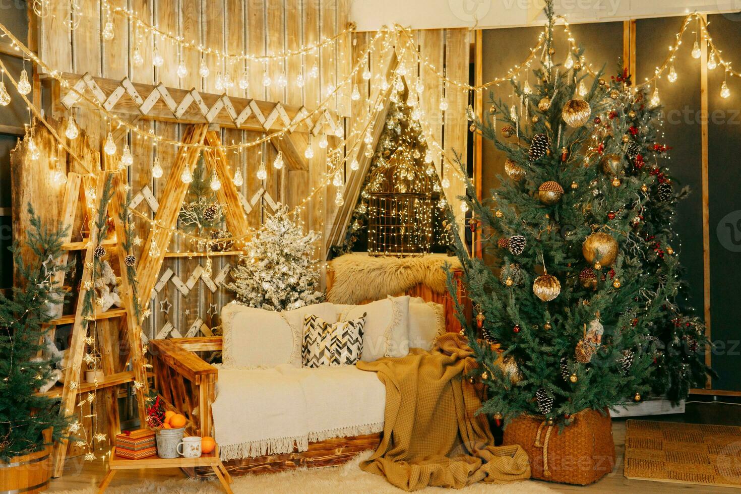 Home Christmas interior, with a Christmas tree and lots of glowing garlands and light bulbs. Preparing for the Christmas party at home. photo