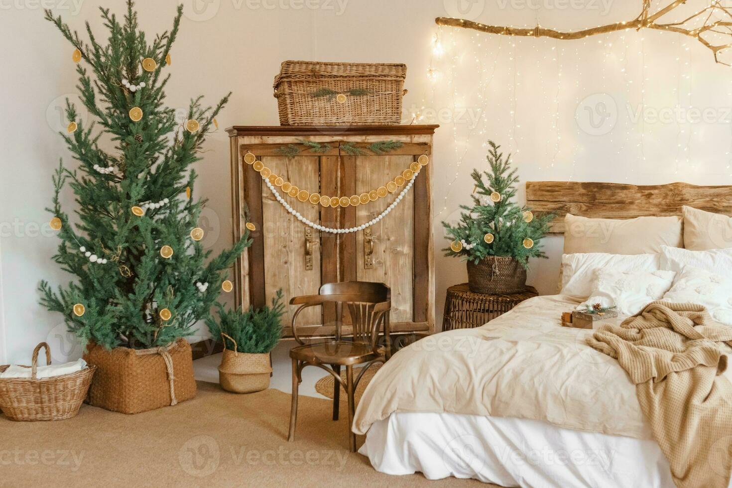 Cozy interior decorated for Christmas in Scandinavian style. Live fir trees decorated with natural ornaments made of dried oranges photo