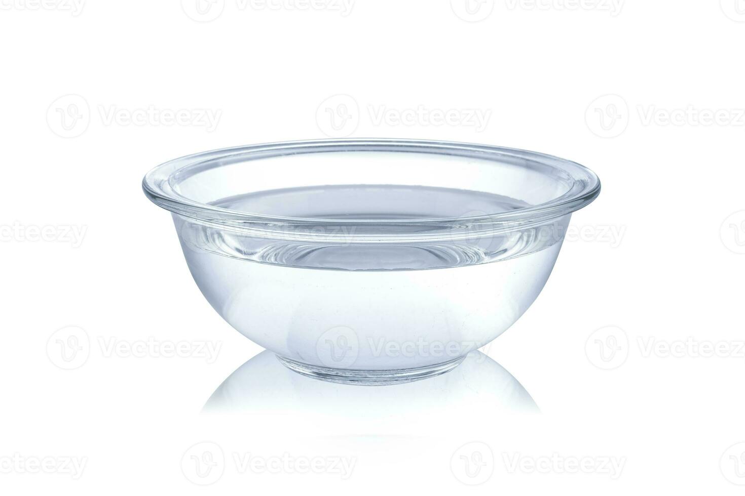 Close up view of glass bowl full of water, Glass bowl isolated with clipping path on white background. Glass plate , mixing bowl, glossy dish. Side view photo