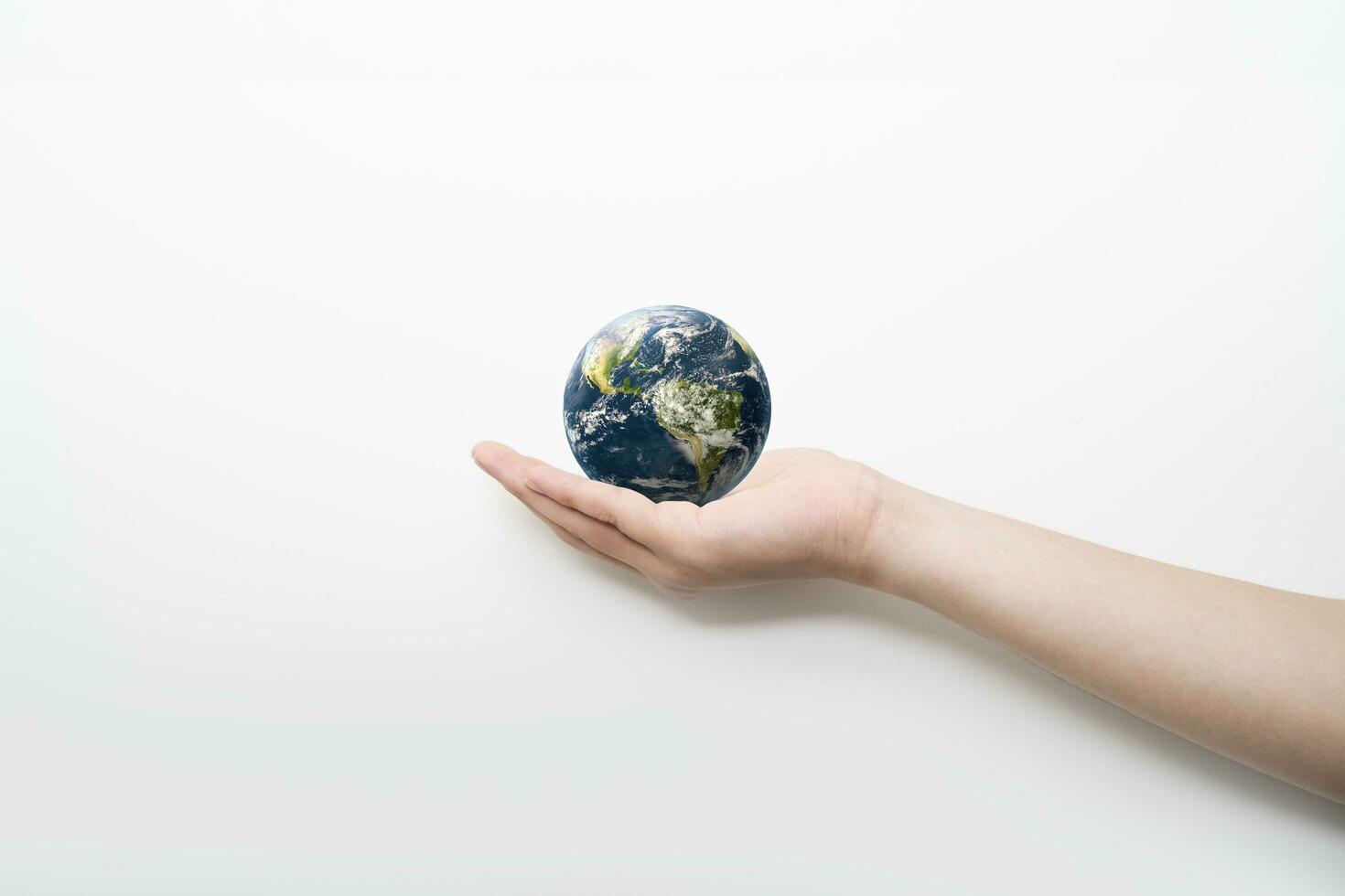 globe blue on hands in white background, earth in adult hands , earth day, world day, energy saving concept, Elements of this image furnished by NASA. photo