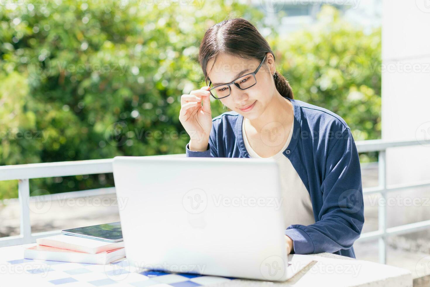 Asian teen girl with laptop computer for online education learning or programmer student in university. photo