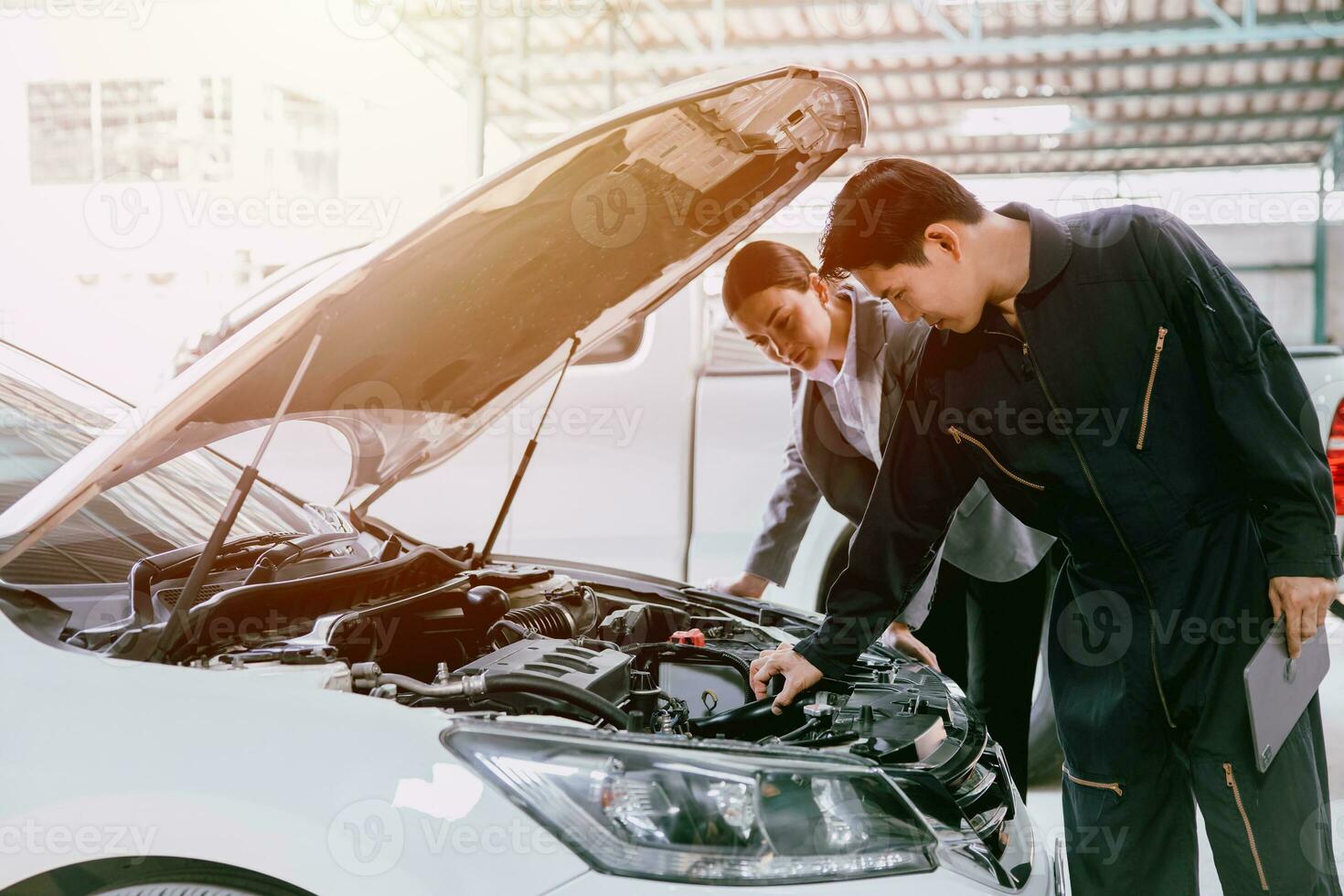 mechanic engineer working checking engine in garage auto shop car insurance claim cost estimate team photo