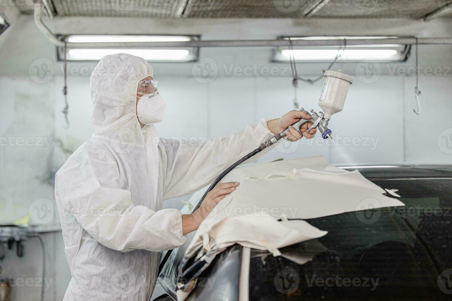 Garage car color repair roof painting wax airbrush coating team staff working in auto workshop photo