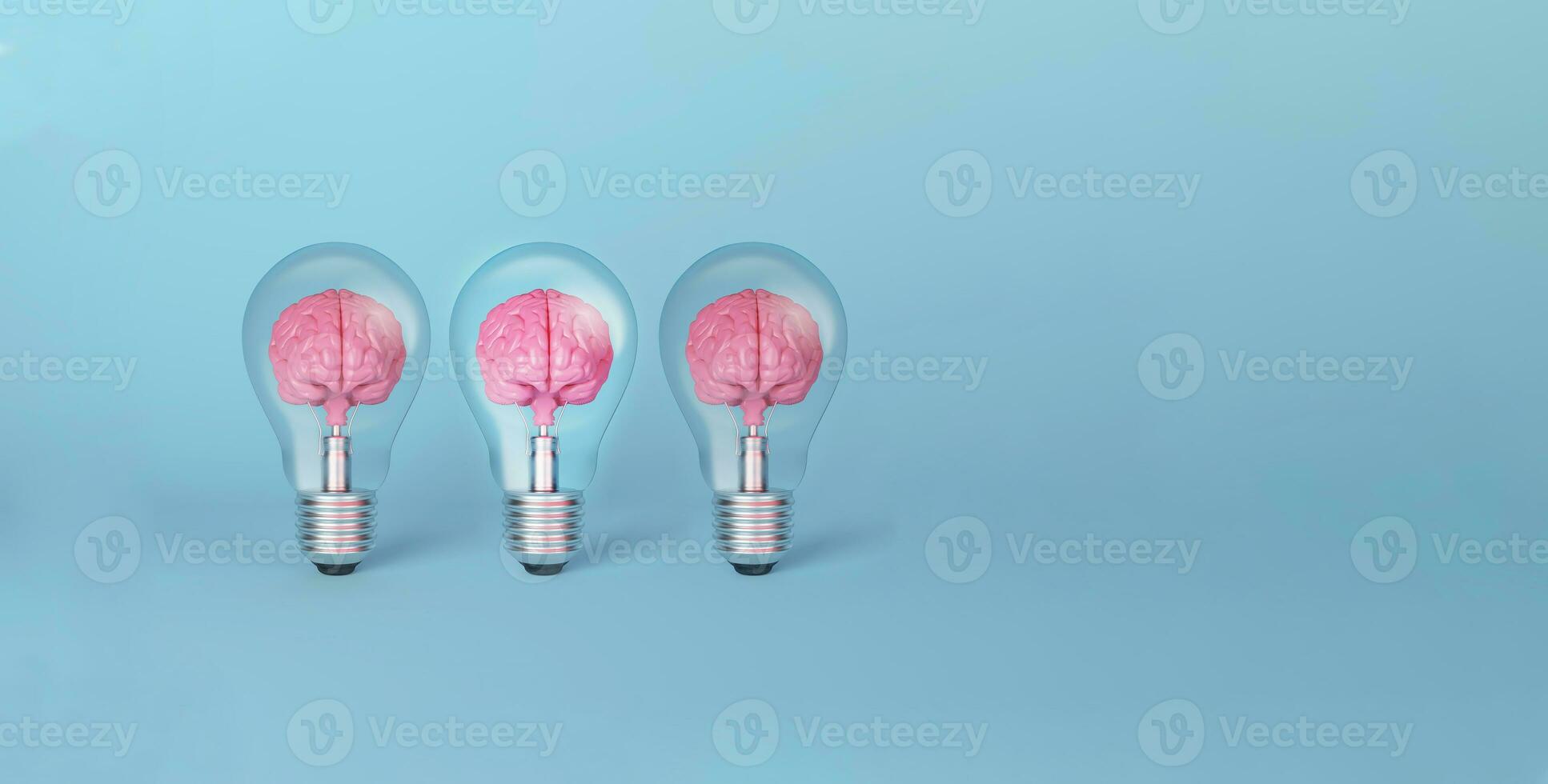 Brain on light bulb illuminated standing out from the crowd on blue background. photo