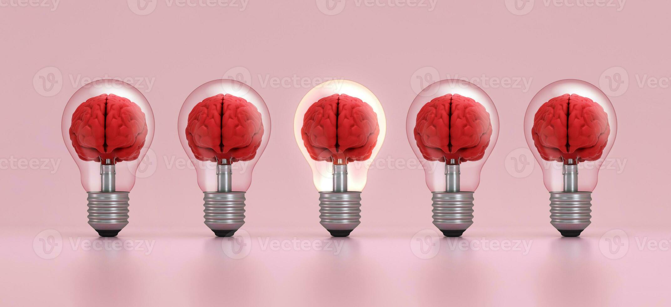 Brain inside a light bulb illuminated standing out from the crowd on pink background. Concept of inspiration. photo