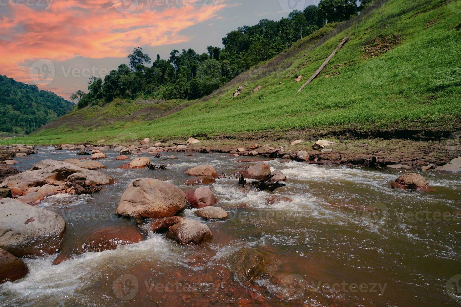 Upstream view on top of the dam Surrounded by mountains and lush nature photo