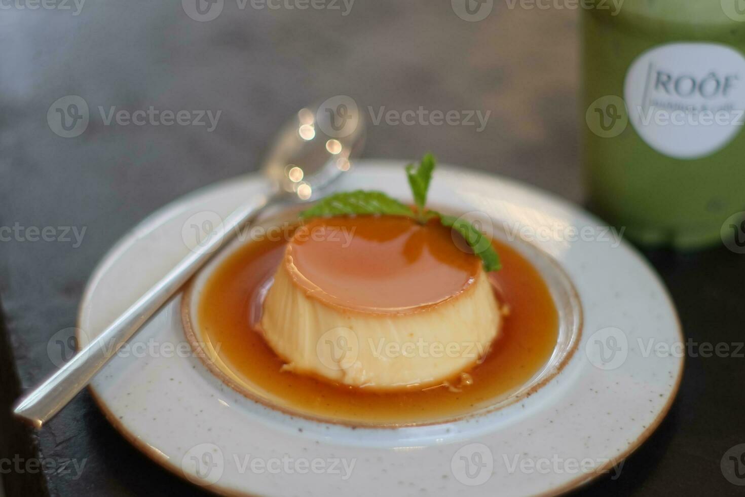 pudding caramel in plate spoon photo