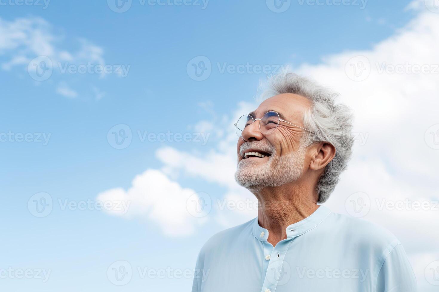 senior man in eyeglasses looking away at the sky. photo