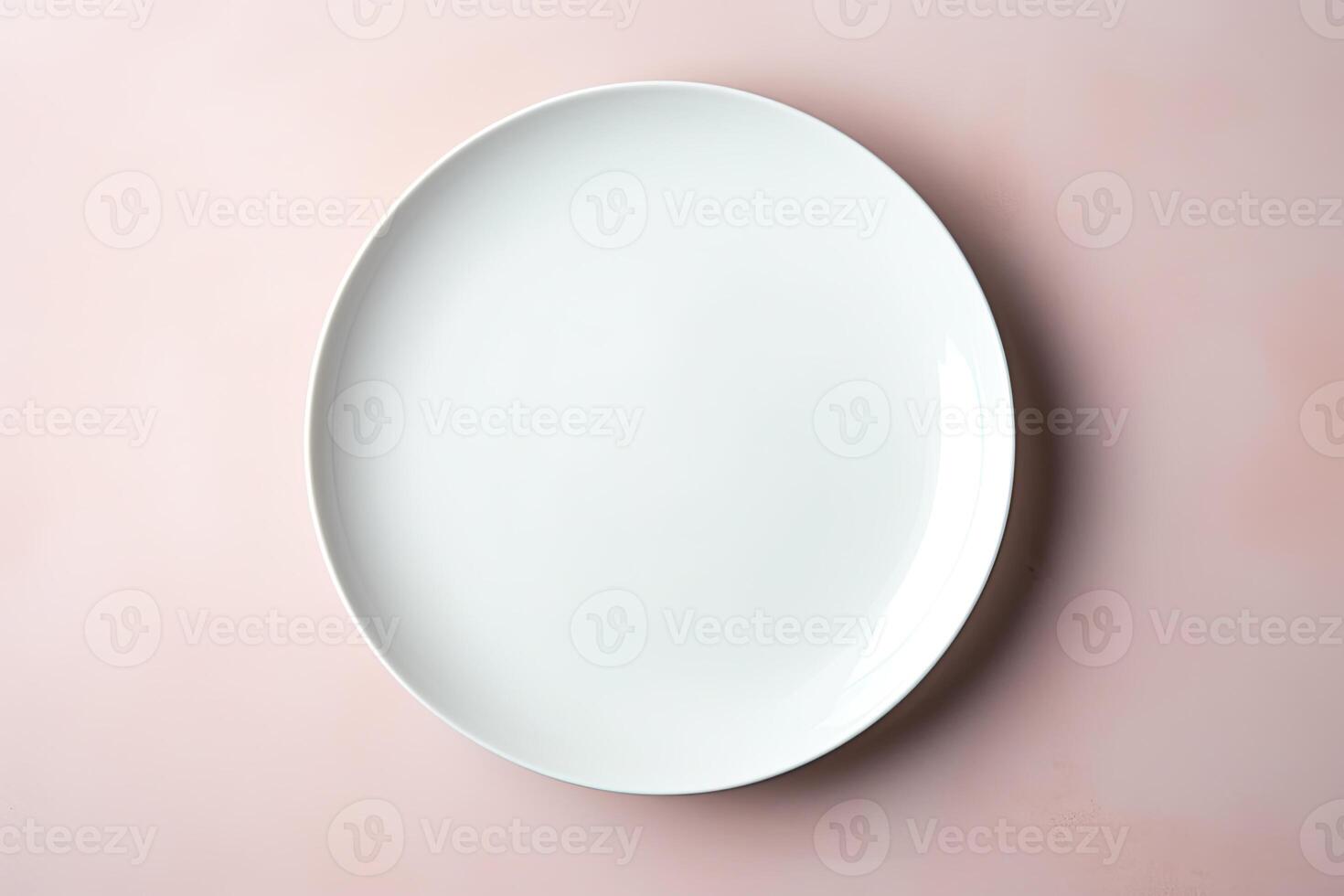 top view of an empty white plate on pink background. photo