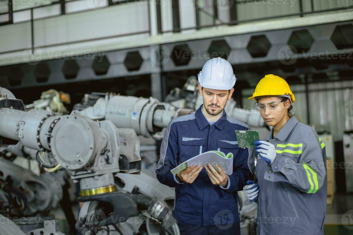 Engineer woman team worker work in Machine Robotic modern Automation Industry. Mechanic staff employee in metal factory. photo