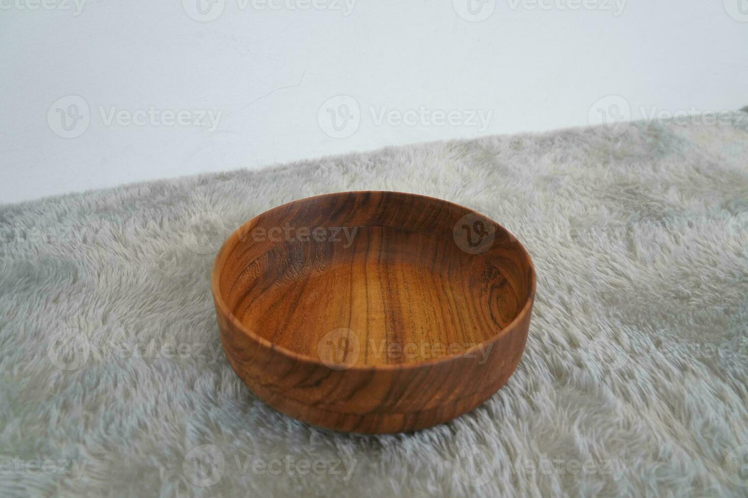 Wooden bowl on grey background photo