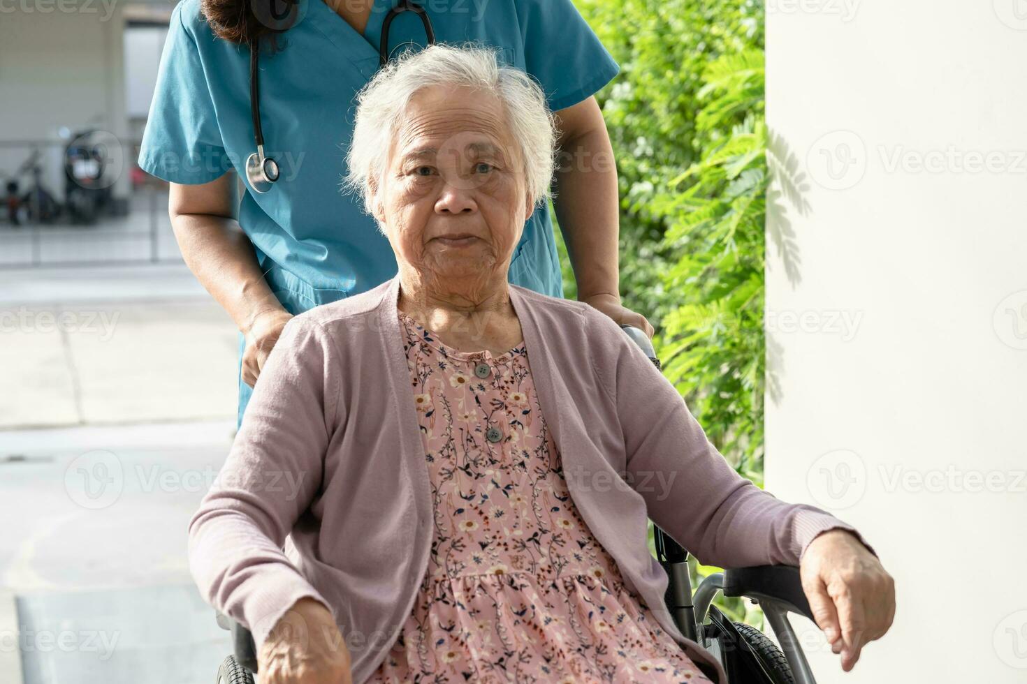 Caregiver help and care Asian senior woman patient sitting on wheelchair to ramp in hospital, healthy strong medical concept. photo