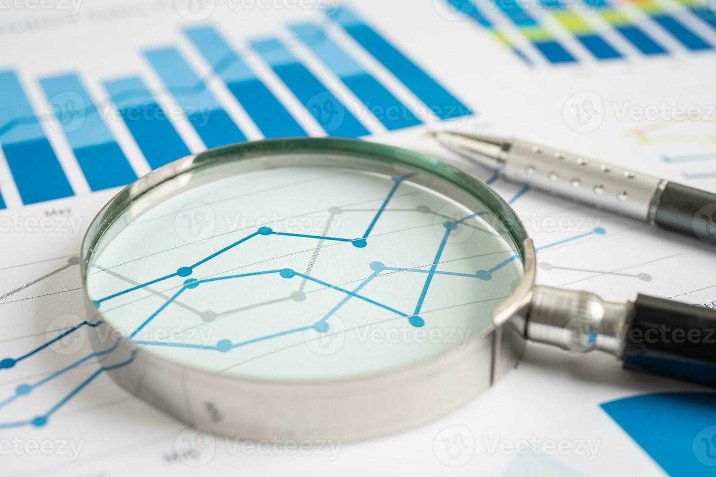 Magnifying glass on graph paper. Financial development, Banking Account, Statistics, Investment Analytic research data economy, Business concept. photo