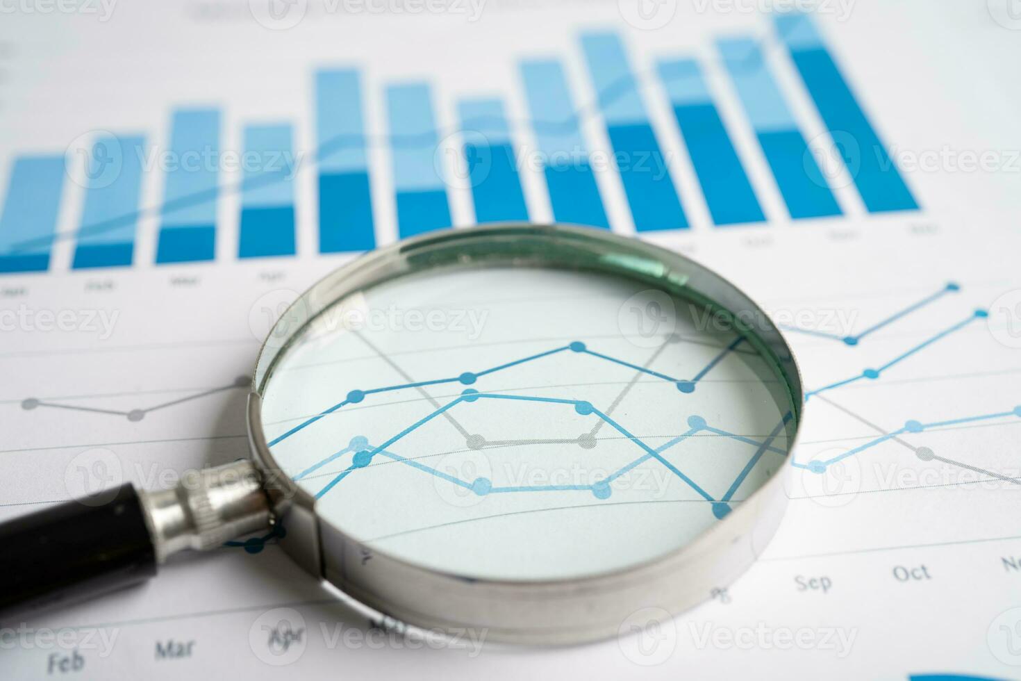 Magnifying glass on graph paper. Financial development, Banking Account, Statistics, Investment Analytic research data economy, Business concept. photo