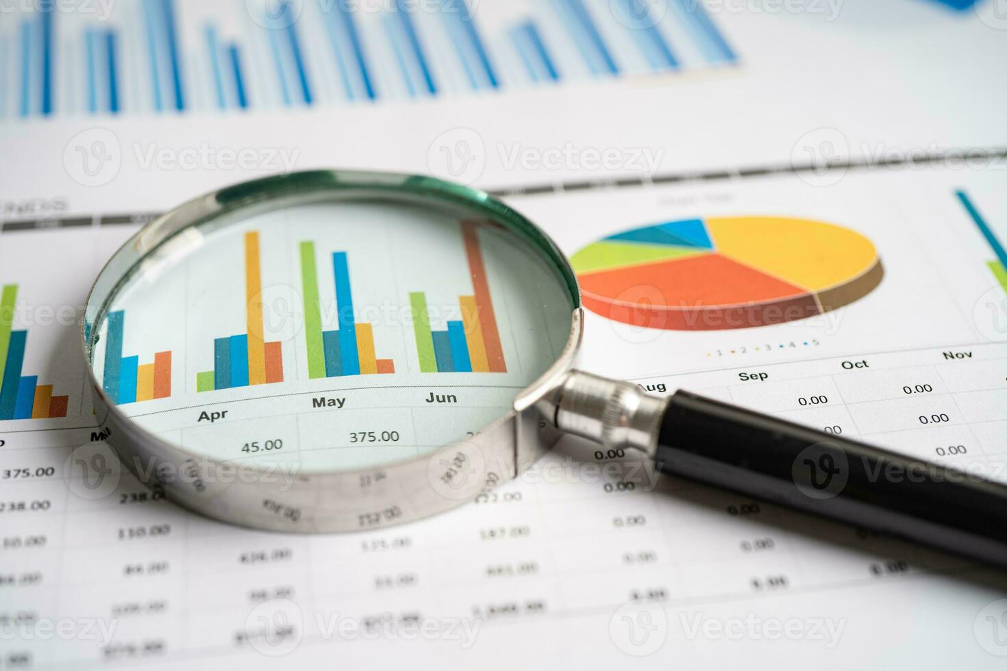 Magnifying glass on graph paper. Financial development, Banking Account, Statistics, Investment Analytic research data economy, Business concept. photo