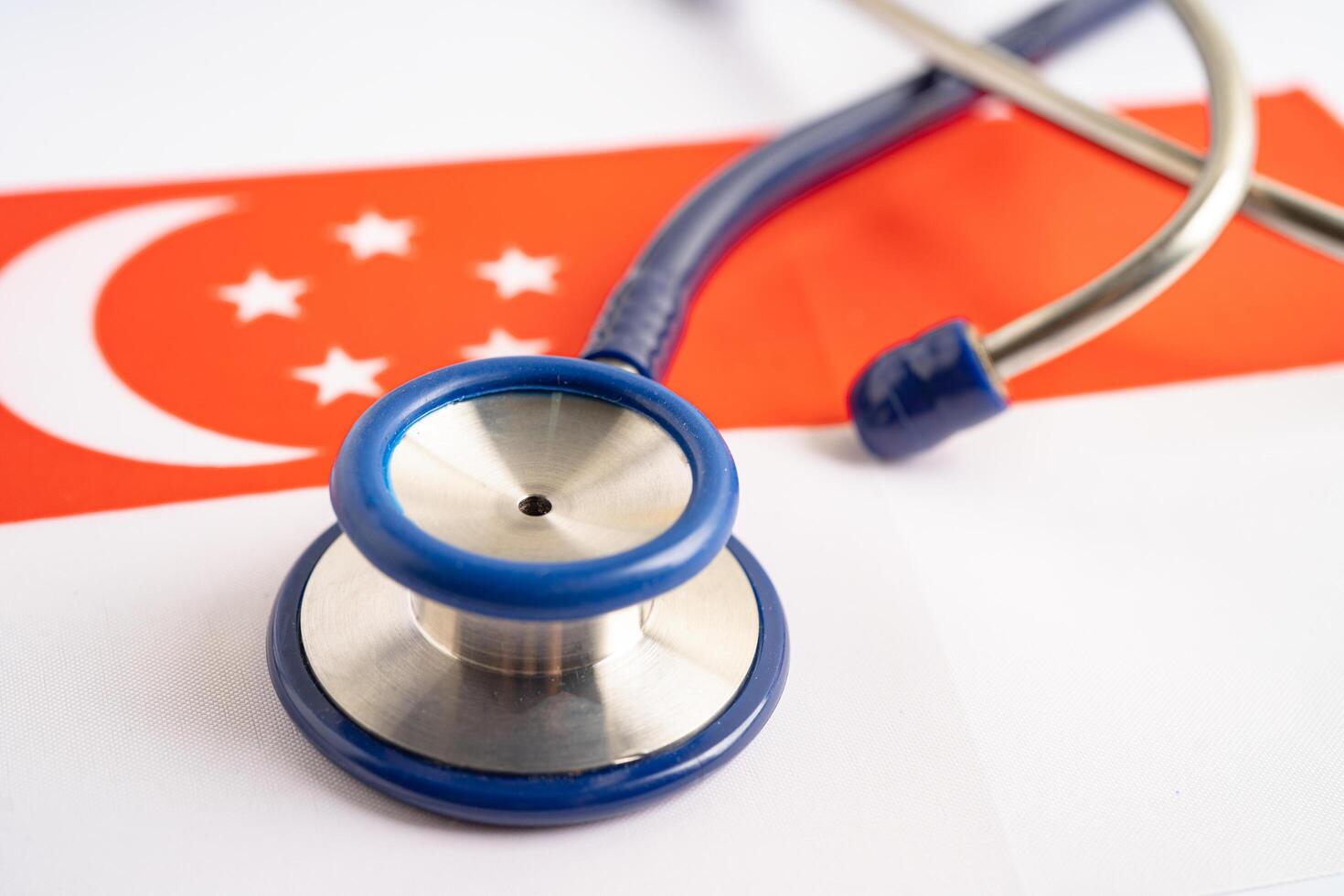 Stethoscope on Singapore flag background, Business and finance concept. photo