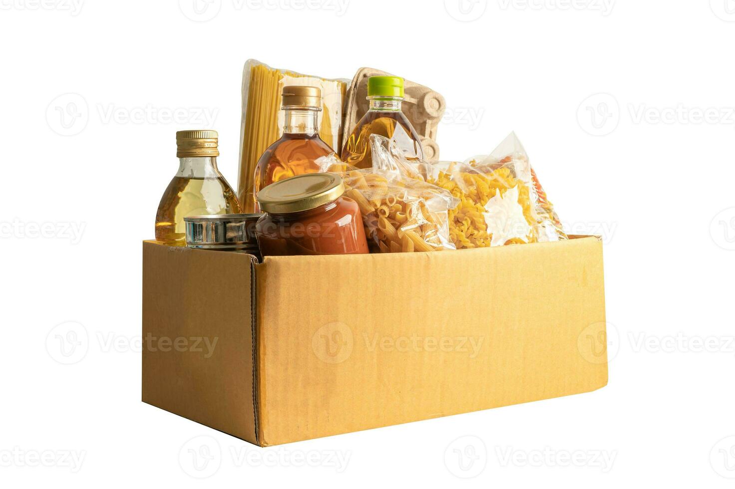 Foodstuff for donation isolated on white background with clipping path, storage and delivery. Various food, pasta, cooking oil and canned food in cardboard box. photo