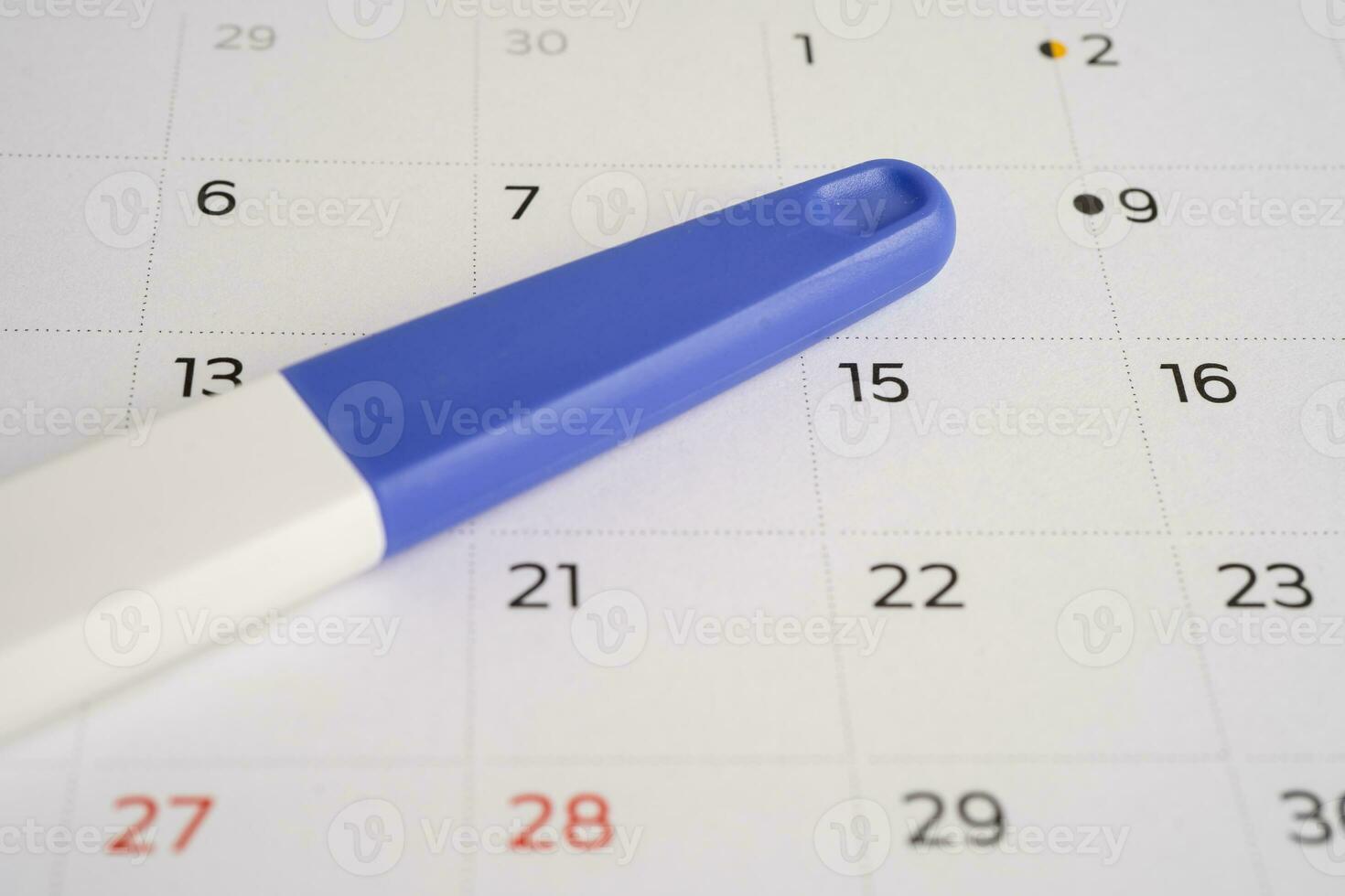 Pregnancy test on calendar, contraception health and medicine. photo