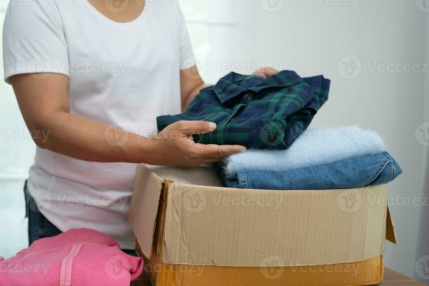 Donation box with used clothes at home to support help for poor people in the world. photo