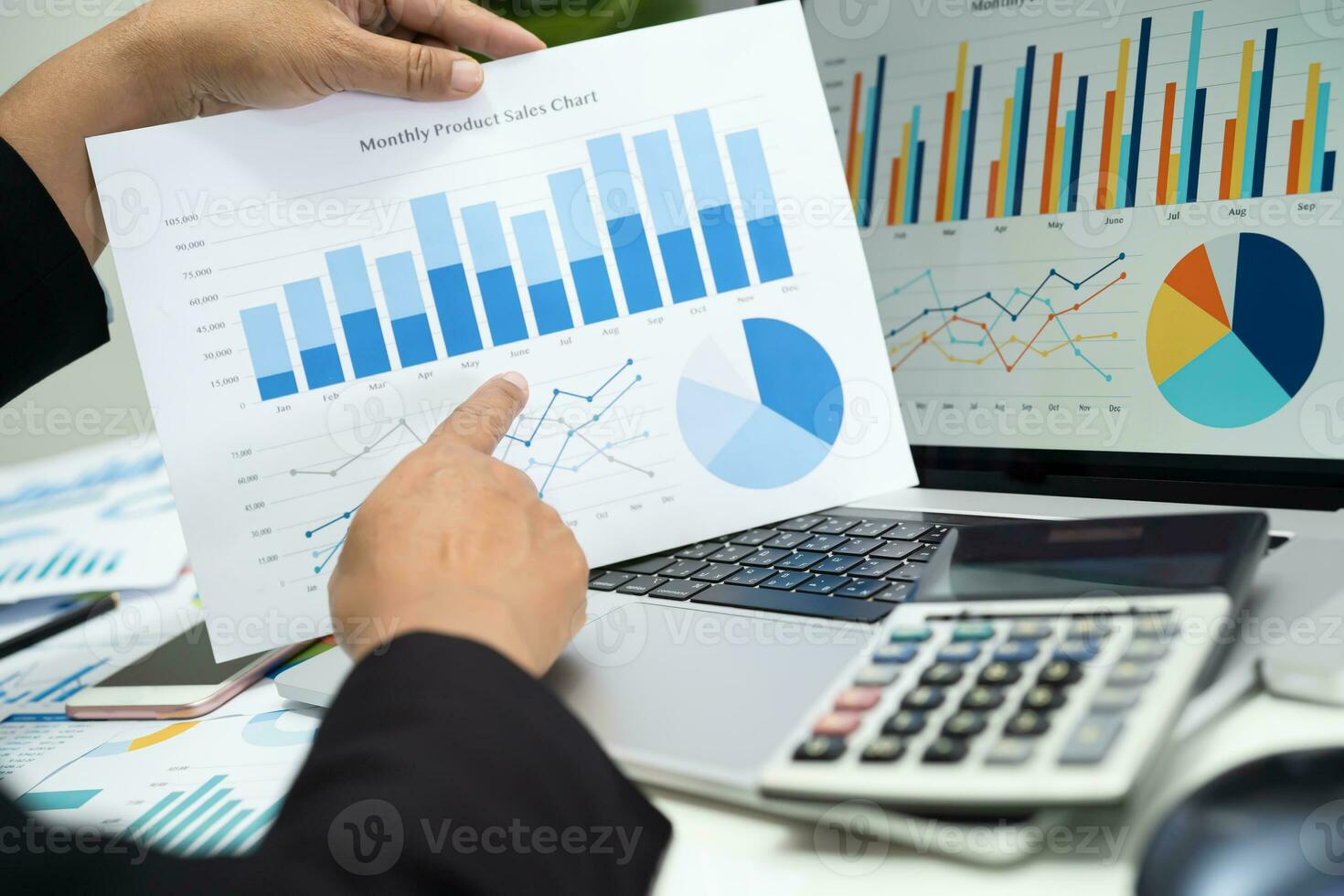 Asian accountant working and analyzing financial reports project accounting with chart graph in modern office, finance and business concept. photo