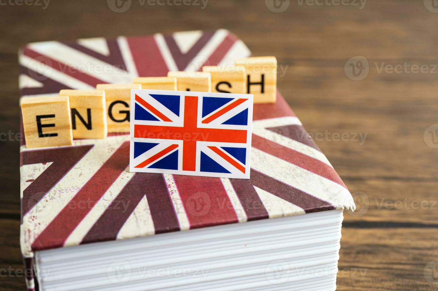 Word English on book with United Kingdom flag, learning English language courses concept. photo