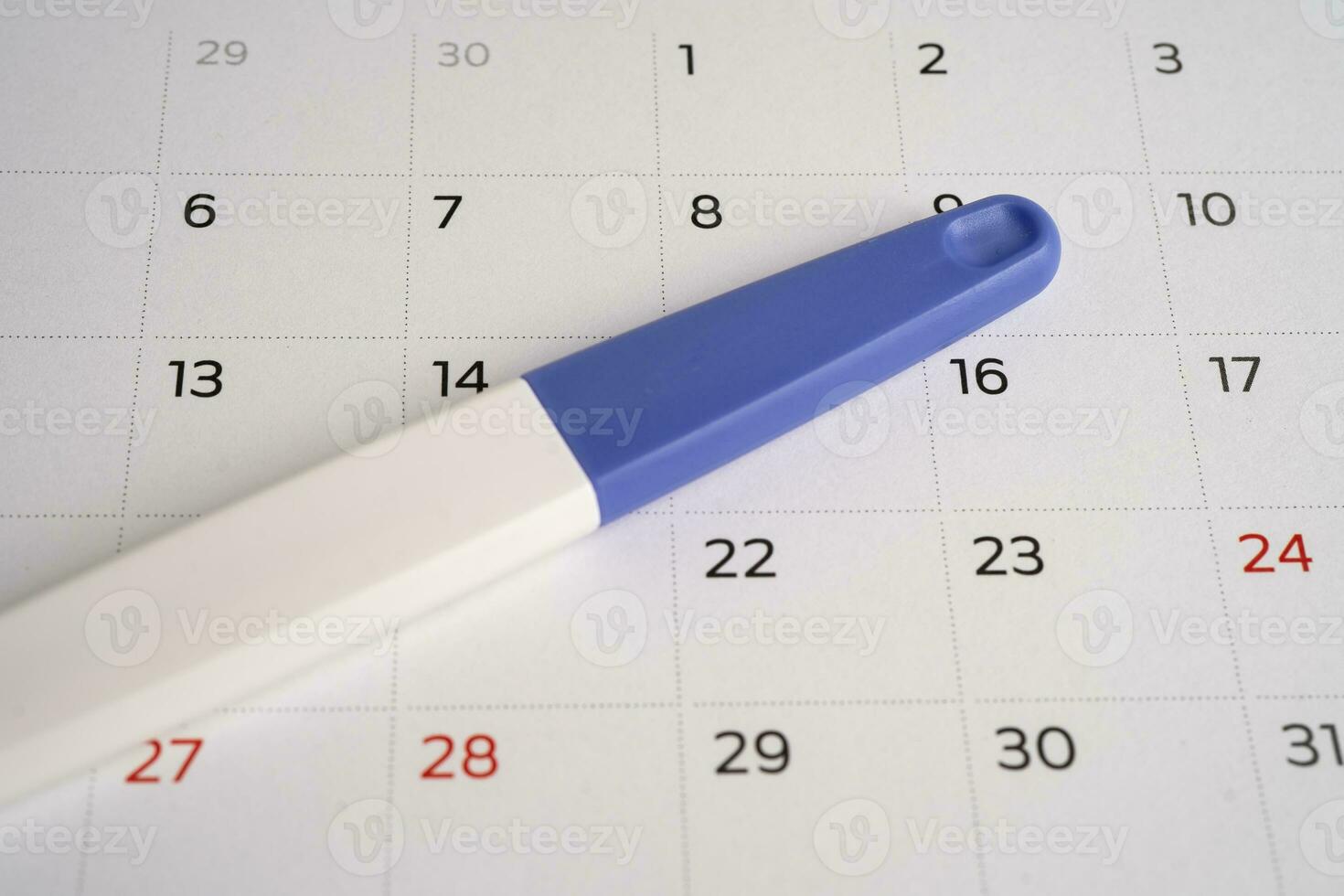 Pregnancy test on calendar, contraception health and medicine. photo