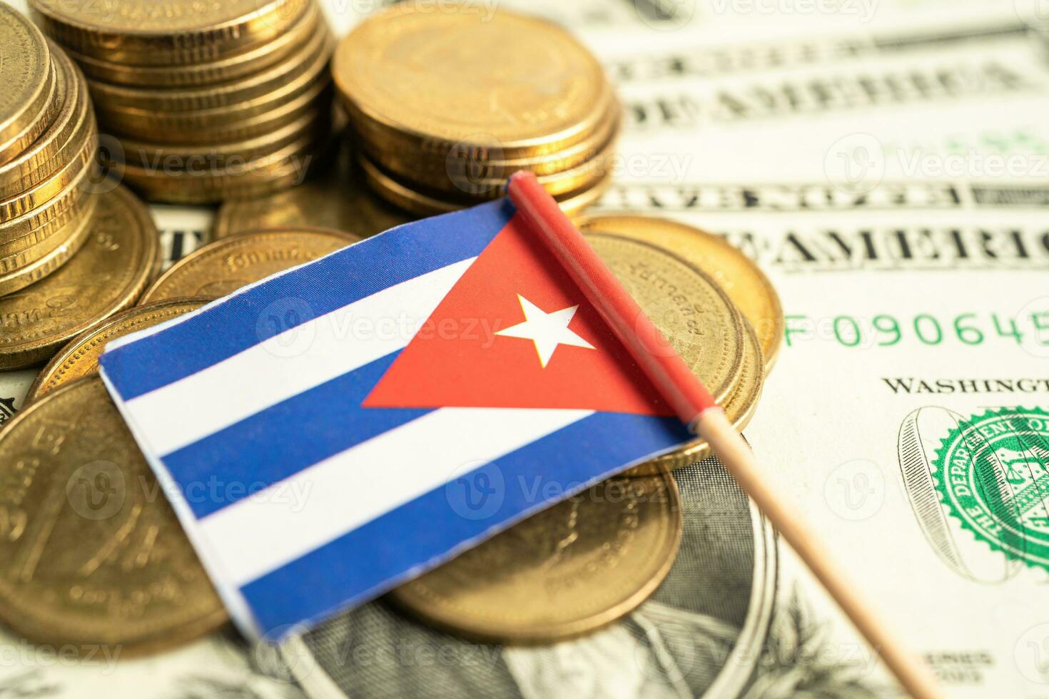 Stack of coins with Cuba flag and US dollar banknotes. photo