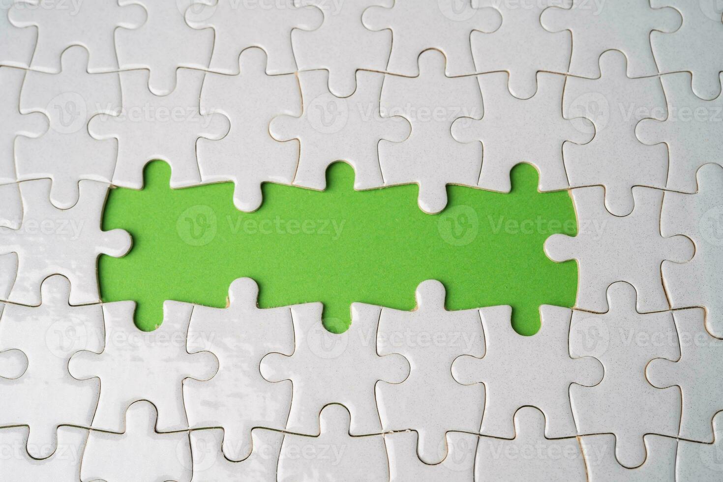 Jigsaw puzzle on green background, business teamwork, problem solving concept. photo