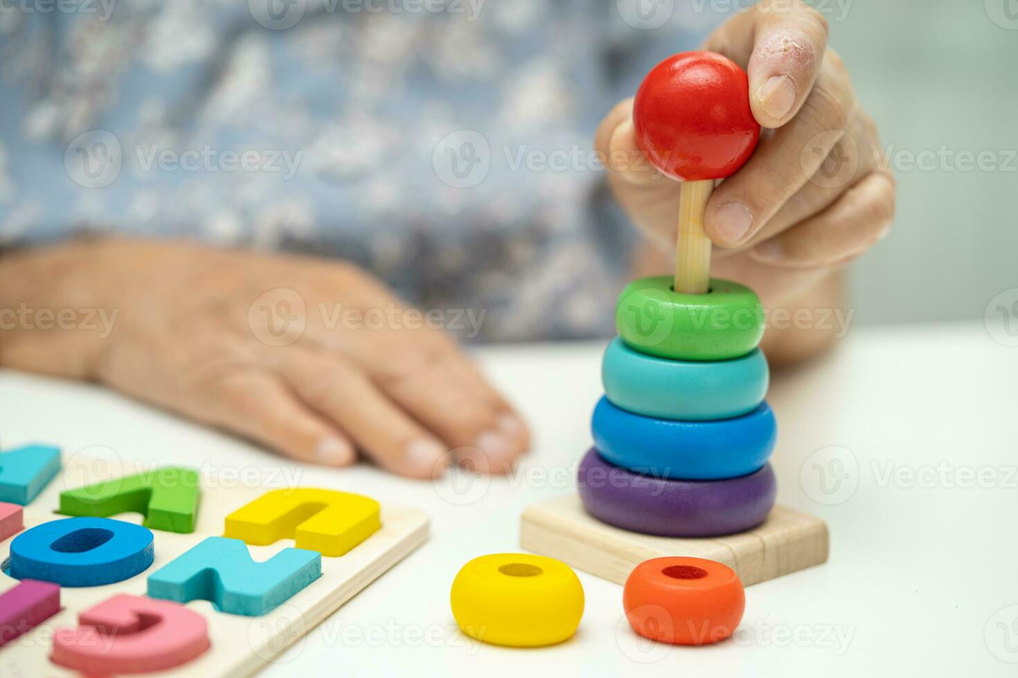 Alzheimer disease AD, Asian elderly woman patient suffering from dementia learn practical motor skills rehabilitation. photo