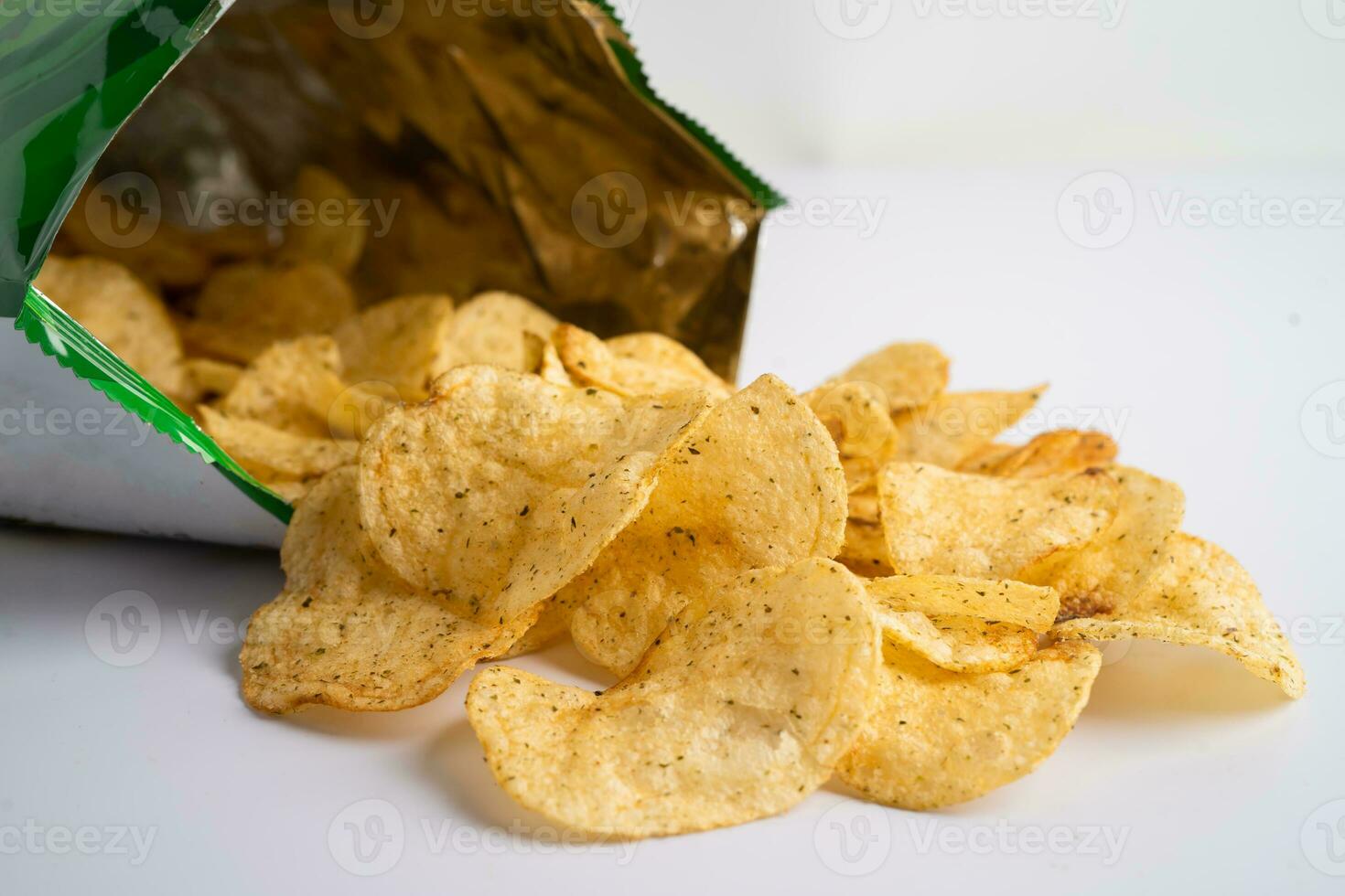 Potato chips, delicious spicy for crips, thin slice deep fried snack fast food in open bag. photo