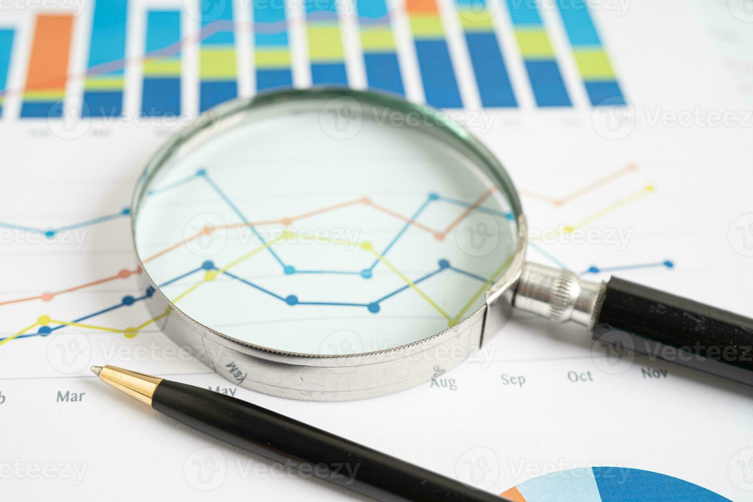 Magnifying glass on graph paper. Financial development, Banking Account, Statistics, Investment Analytic research data economy, Business concept. photo