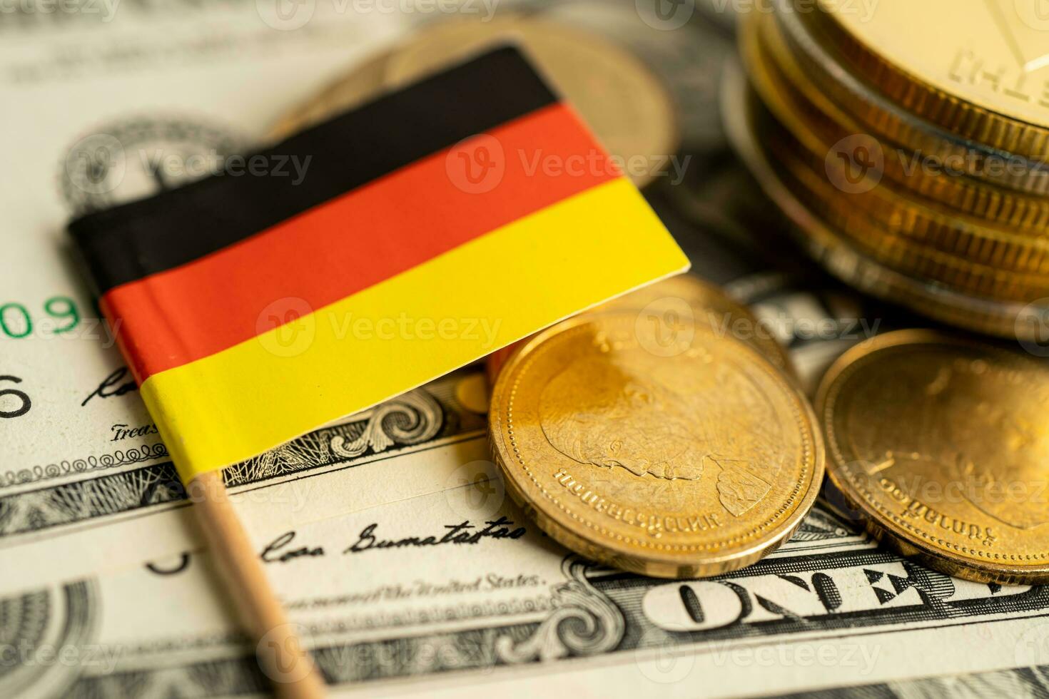 Stack of coins with Germany flag and US dollar banknotes. photo