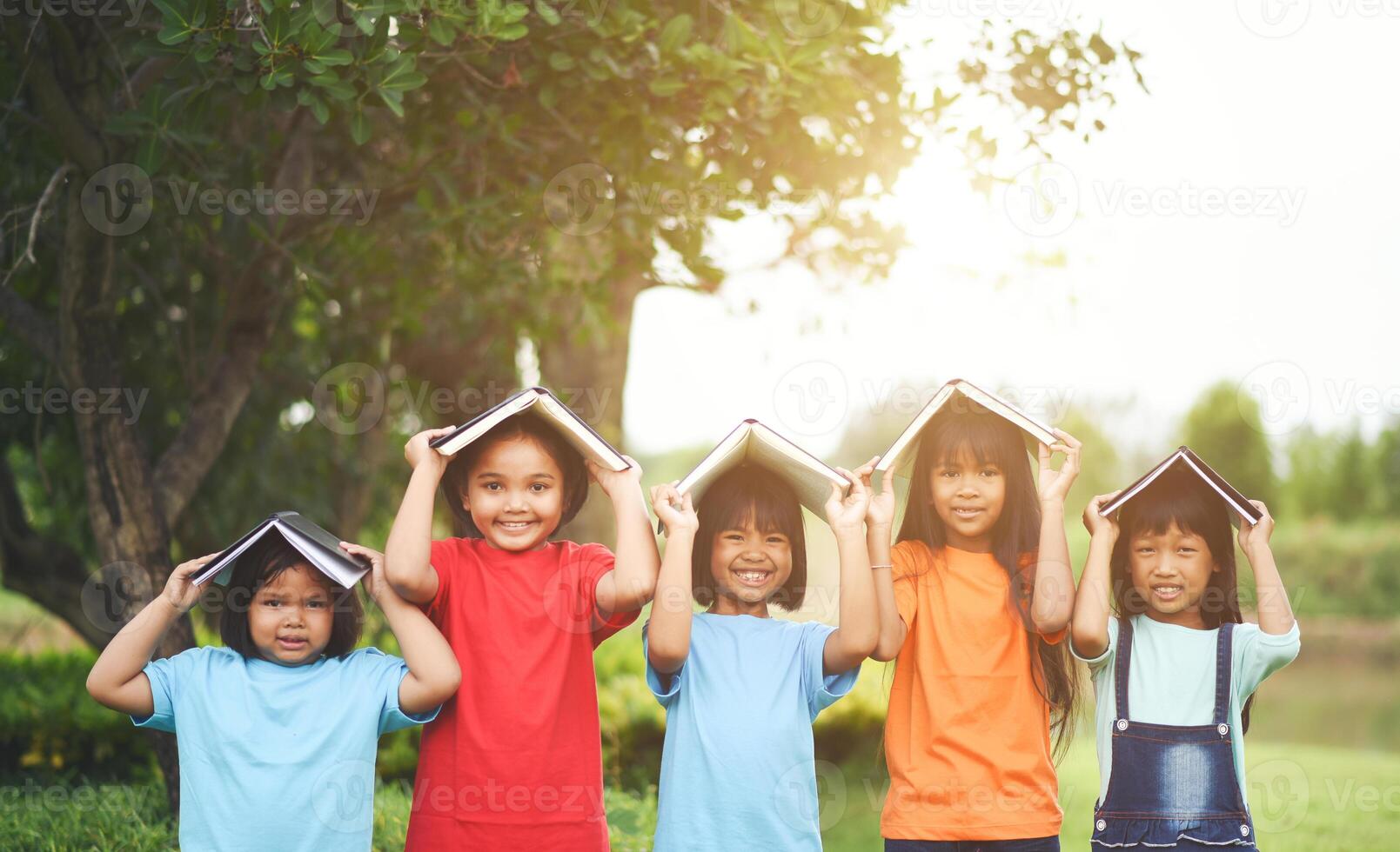 Close up of girl child friends in a park smiling to camera photo