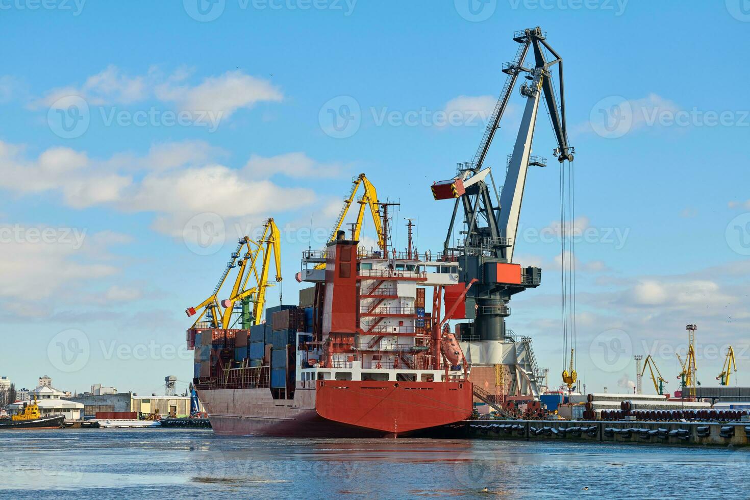 Moored ships and harbor cranes in port photo